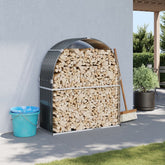 Anthracite galvanized steel log holder with arched roof, holding stacked firewood outdoors.
